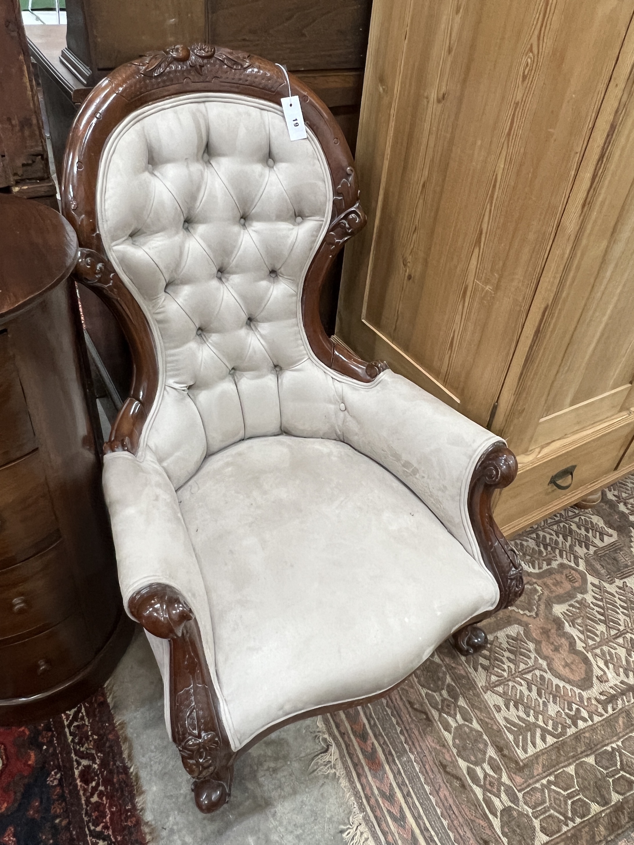 A Victorian style faux suede mahogany spoon back armchair, width 70cm, depth 82cm, height 100cm